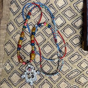 Antique handcrafted trade beads in old coral, branded amber & antique sterling.